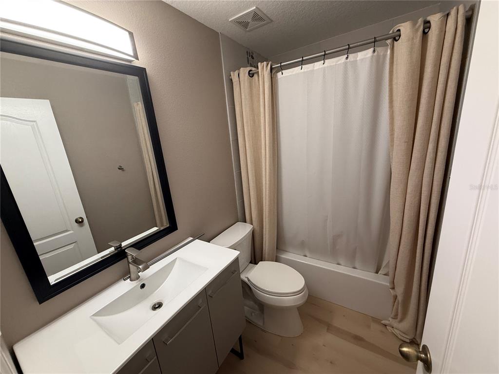 3753 Herlong Street New Port Richey, FL 34655 - Photo 15 of 18 a bathroom with a sink a toilet a mirror and shower