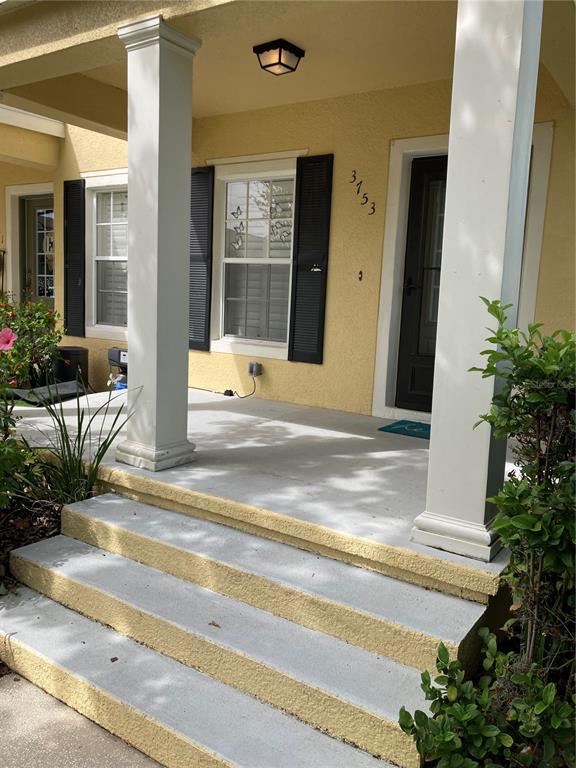 3753 Herlong Street New Port Richey, FL 34655 - Photo 2 of 18 a view of a house with a patio door and a fountain