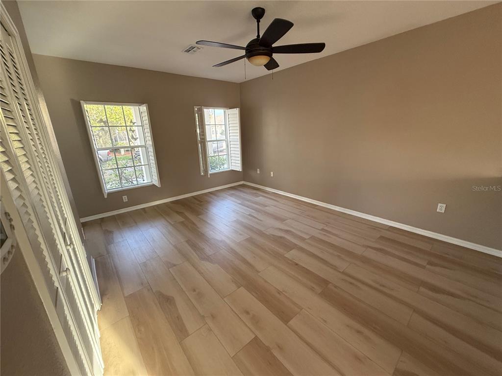 3753 Herlong Street New Port Richey, FL 34655 - Photo 4 of 18 wooden floor in an empty room with a window