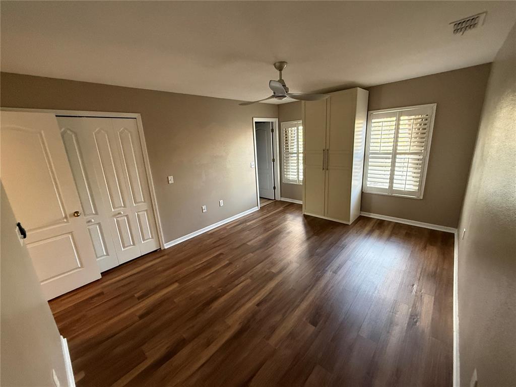 3753 Herlong Street New Port Richey, FL 34655 - Photo 9 of 18 a view of an empty room with wooden floor and a window