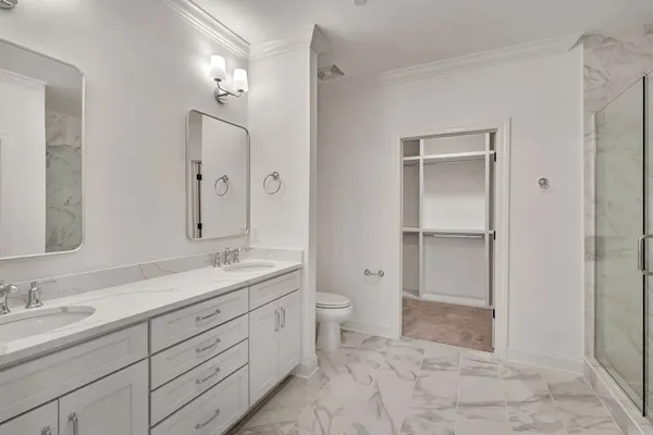 a spacious bathroom with a granite countertop sink mirror and double