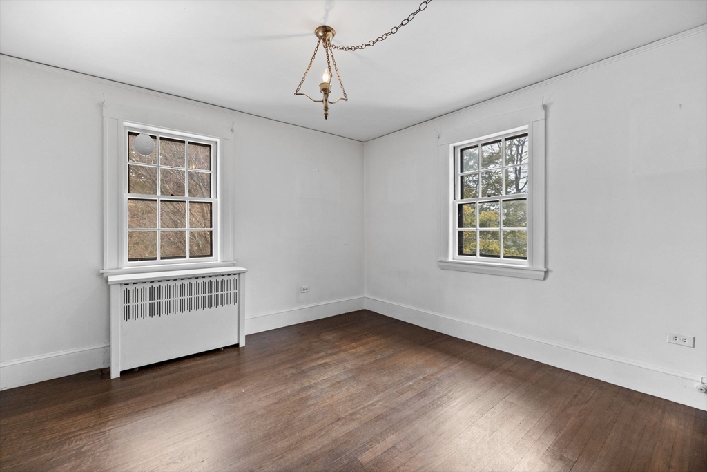 30 Swan Road Winchester, MA 01890 - Photo 26 of 38 an empty room with wooden floor cabinet and windows