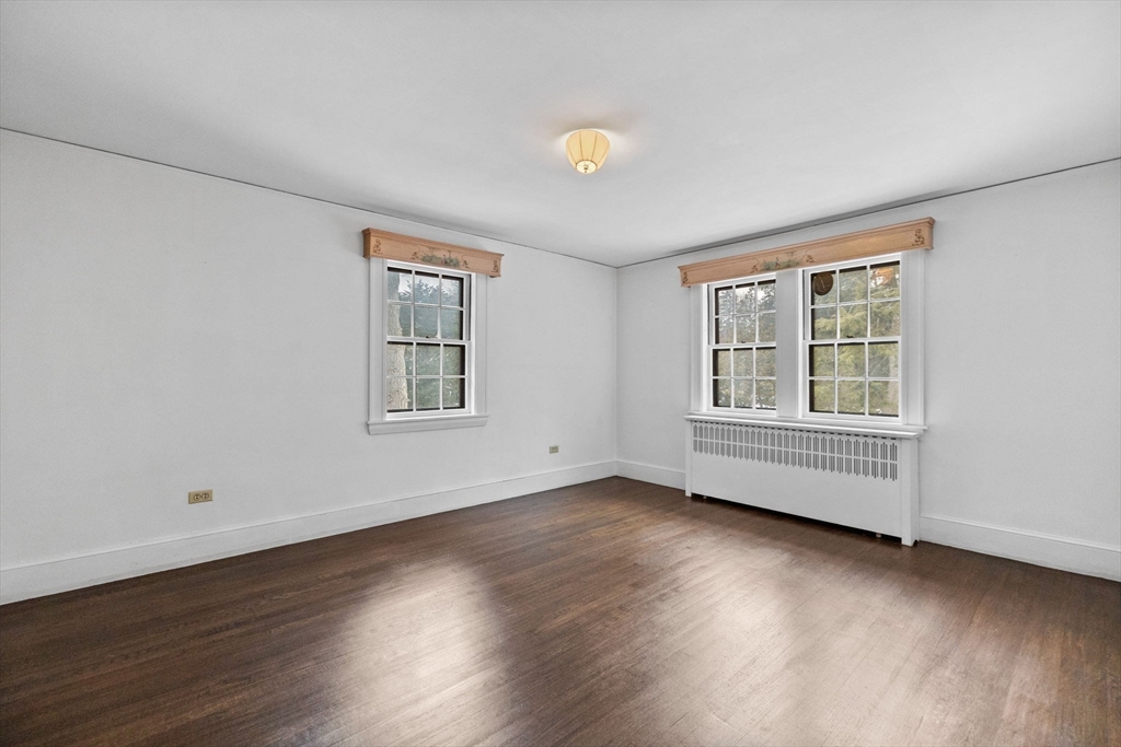 30 Swan Road Winchester, MA 01890 - Photo 28 of 38 a view of an empty room with wooden floor and a window