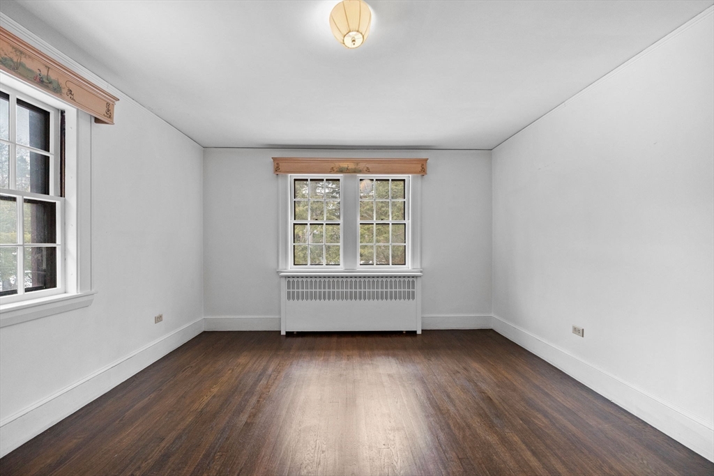 30 Swan Road Winchester, MA 01890 - Photo 29 of 38 an empty room with wooden floor and windows