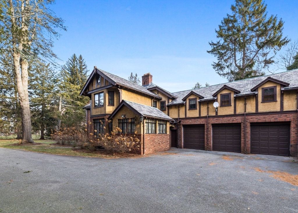 30 Swan Road Winchester, MA 01890 - Photo 5 of 38 a front view of a house with a yard and garage
