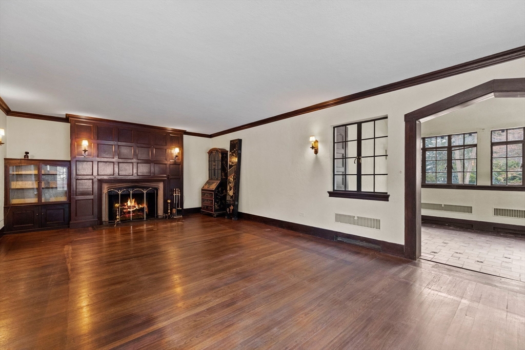 30 Swan Road Winchester, MA 01890 - Photo 7 of 38 a view of an empty room with wooden floor fireplace and a window