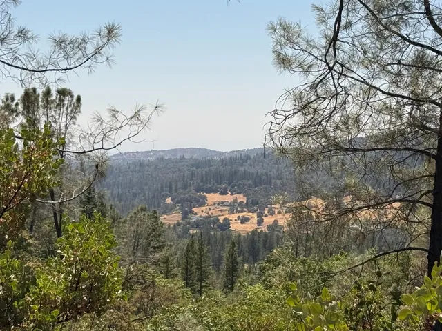 a aerial view of a house with a yard basket ball court and outdoor seating