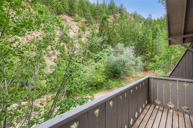 a balcony with trees in front of it