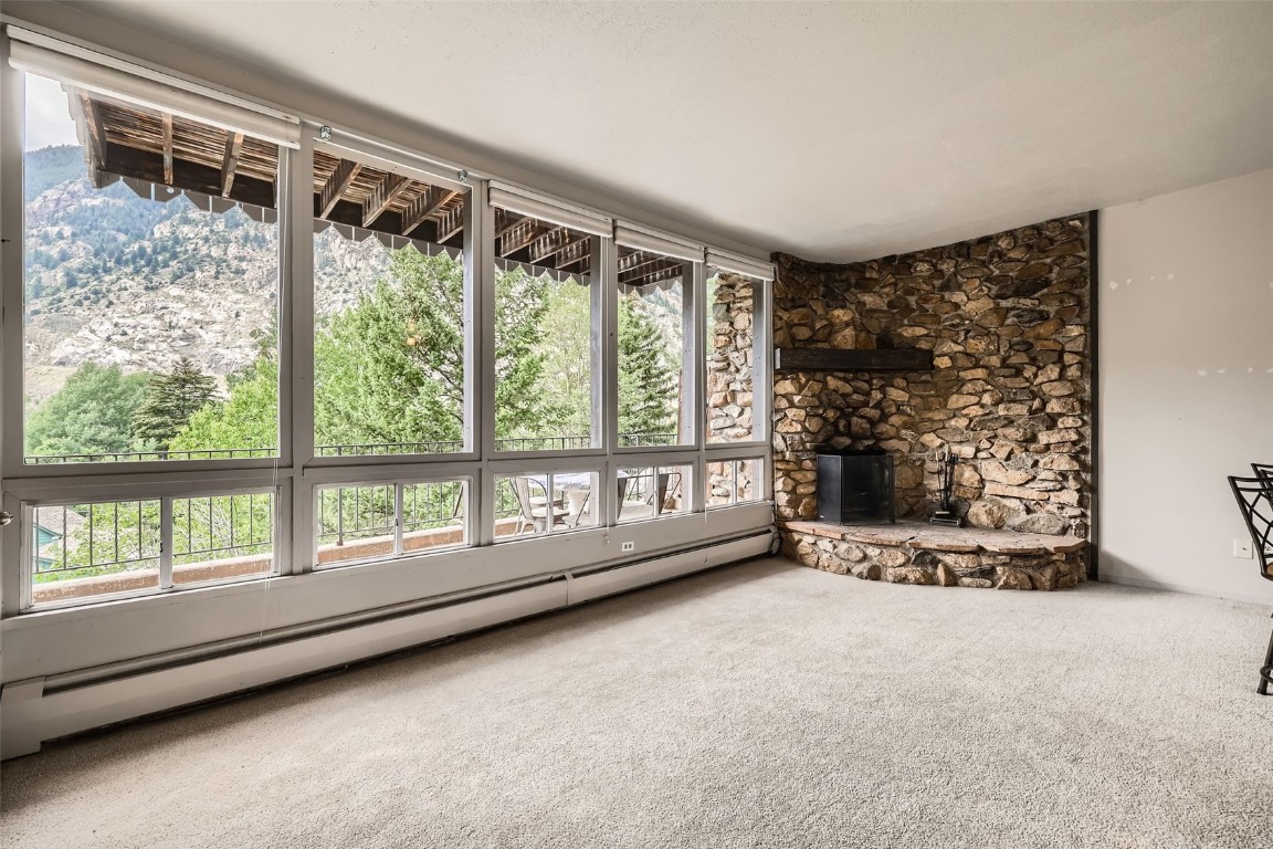 817 Valley View Drive Georgetown, CO 80444 - Photo 3 of 29 a view of an empty room with wooden floor and a window