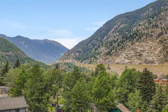 a view of a large mountain with a mountain in the background