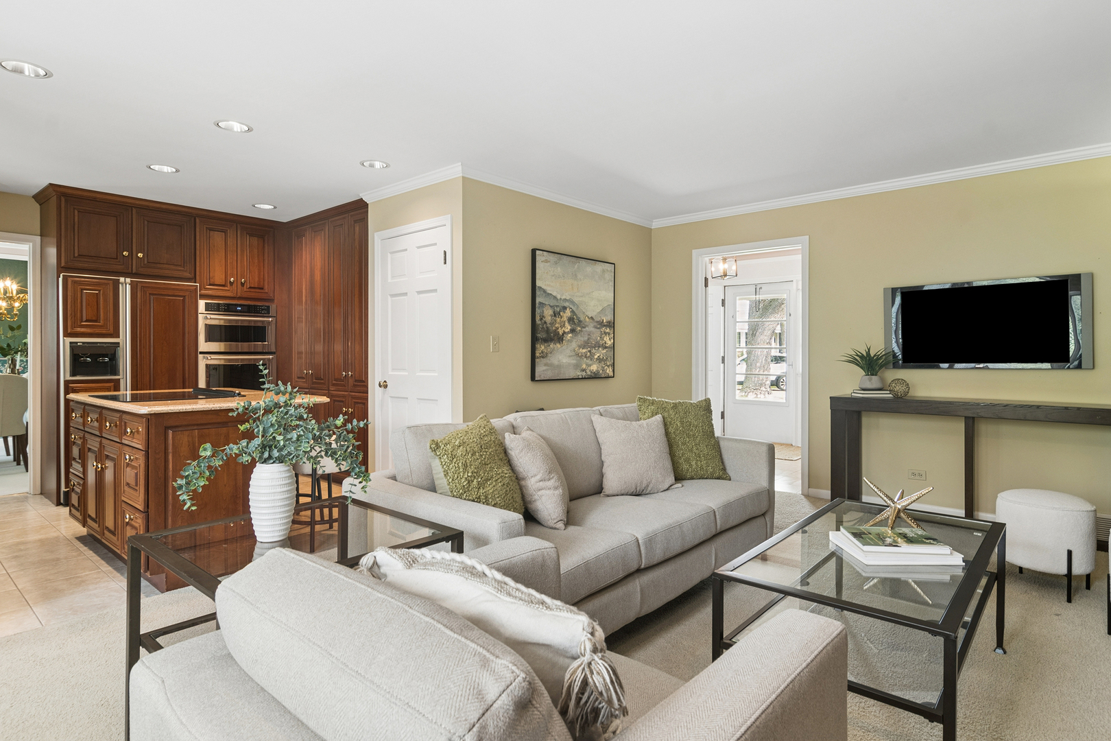 572 East Monterey Road Palatine, IL 60074 - Photo 9 of 27 a living room with furniture a flat screen tv and kitchen view