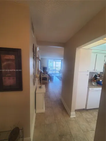 a kitchen with a refrigerator and a sink