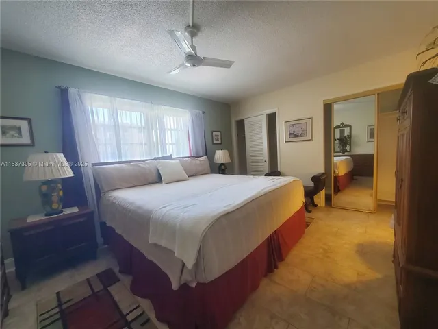 a spacious bedroom with a bed and window