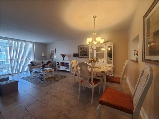 a view of a dining room with furniture and chandelier