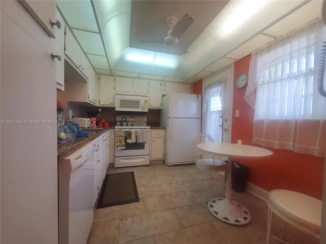 a kitchen with stainless steel appliances kitchen island granite countertop a sink and cabinets
