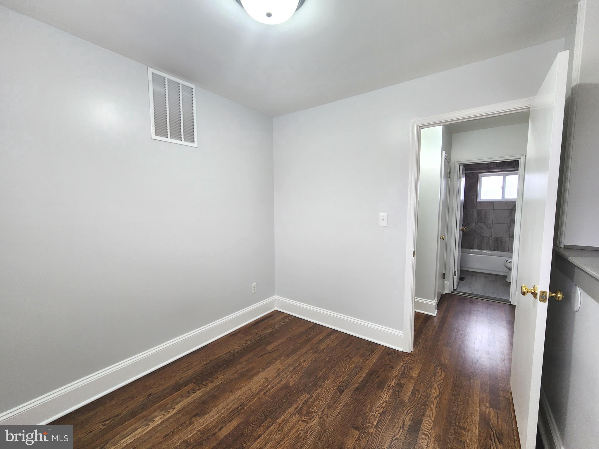 914 Vanderwood Road Catonsville, MD 21228 - Photo 13 of 23 an empty room with wooden floor and windows