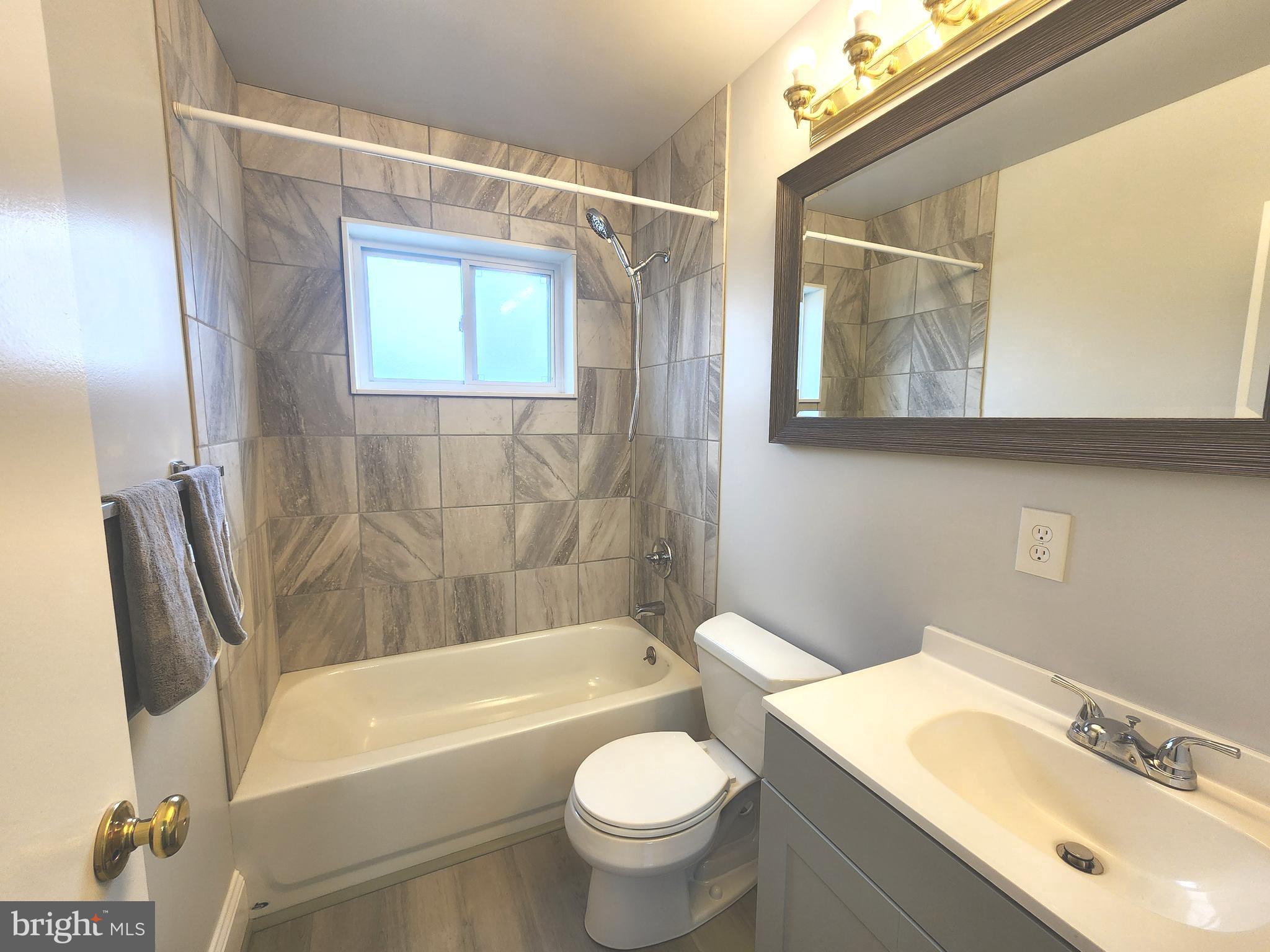 914 Vanderwood Road Catonsville, MD 21228 - Photo 16 of 23 a bathroom with a sink a mirror a toilet and a bathtub