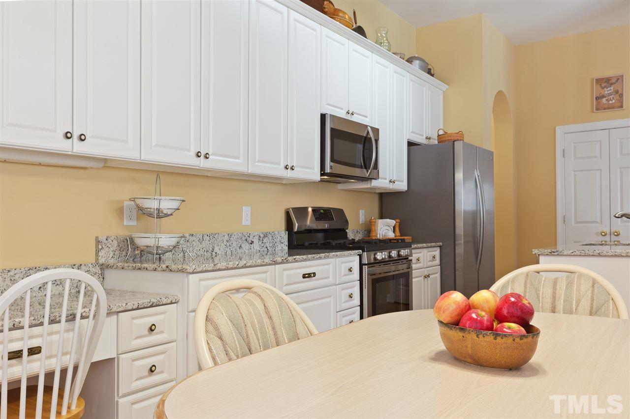 4008 Batiste Road Raleigh, NC 27613 - Photo 13 of 24 a kitchen with stainless steel appliances white cabinets a sink and a stove