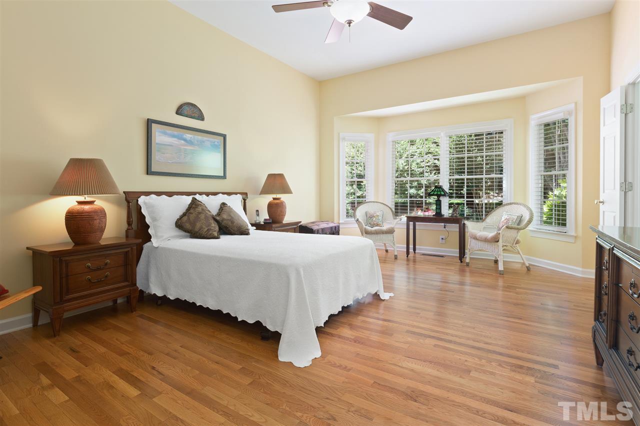 4008 Batiste Road Raleigh, NC 27613 - Photo 14 of 24 a bedroom with a bed and wooden floor