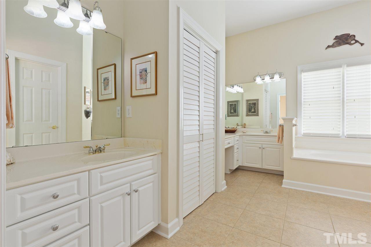 4008 Batiste Road Raleigh, NC 27613 - Photo 16 of 24 a spacious bathroom with a granite countertop sink mirror and a bathtub