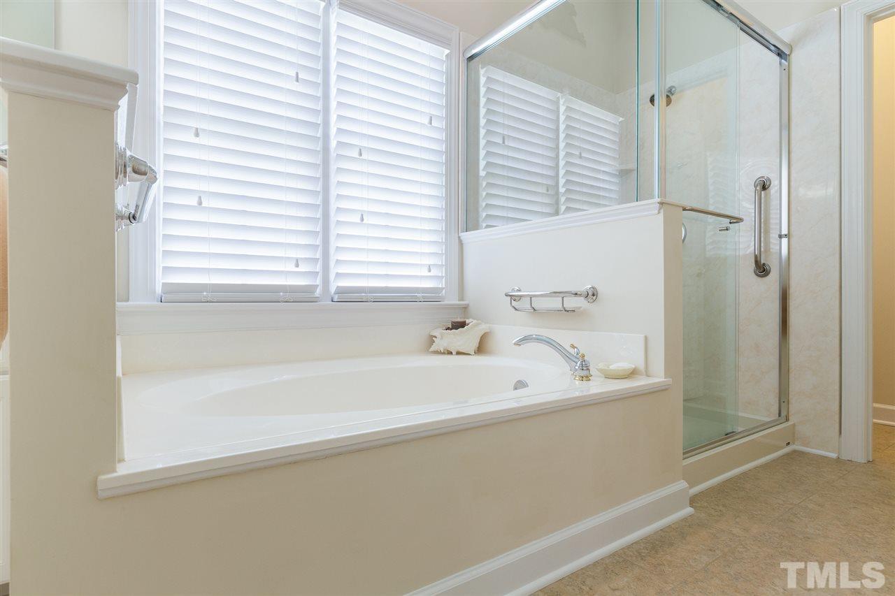 4008 Batiste Road Raleigh, NC 27613 - Photo 17 of 24 a bathroom with a bathtub and a shower