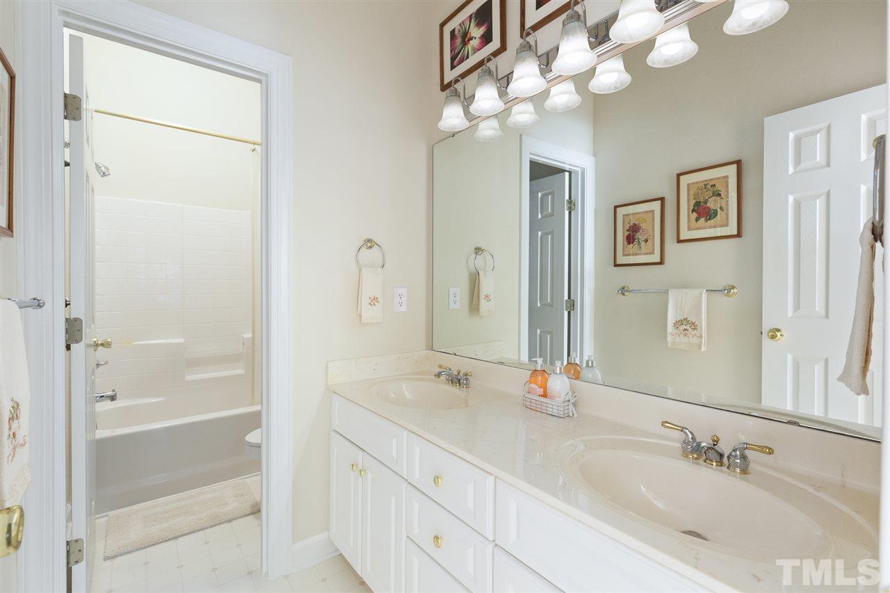4008 Batiste Road Raleigh, NC 27613 - Photo 20 of 24 a bathroom with a double vanity sink and a mirror