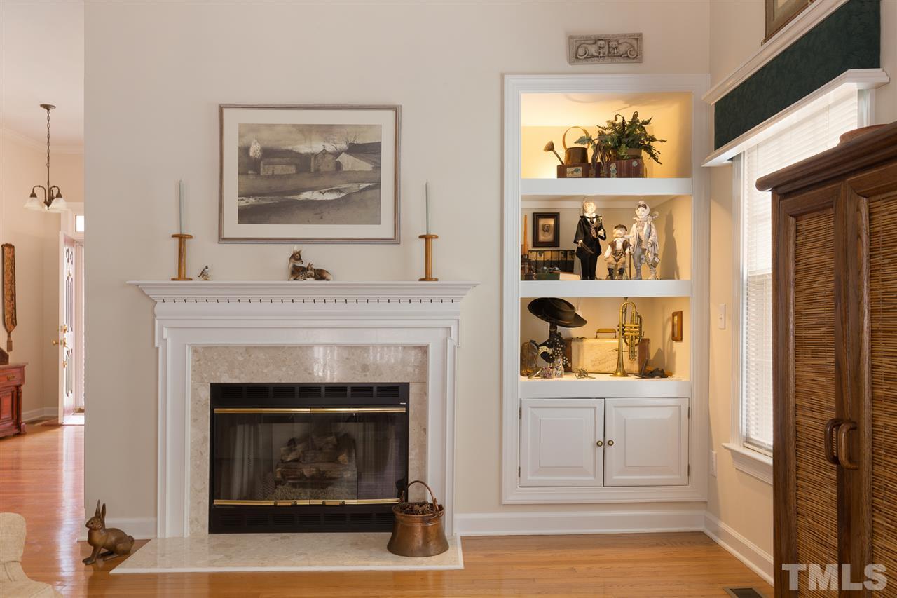 4008 Batiste Road Raleigh, NC 27613 - Photo 7 of 24 a living room with a fireplace and a window
