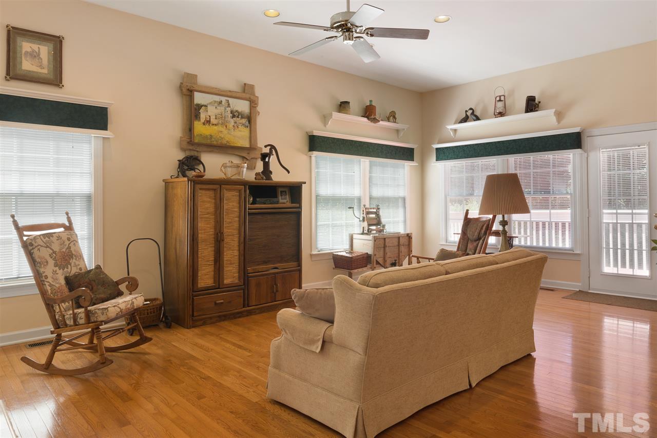 4008 Batiste Road Raleigh, NC 27613 - Photo 8 of 24 a living room with furniture and a chandelier