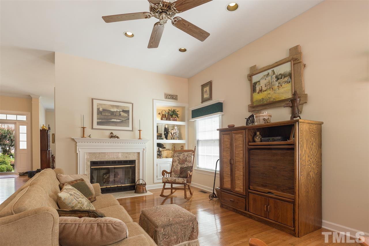 4008 Batiste Road Raleigh, NC 27613 - Photo 9 of 24 a living room with furniture a flat screen tv and a fireplace