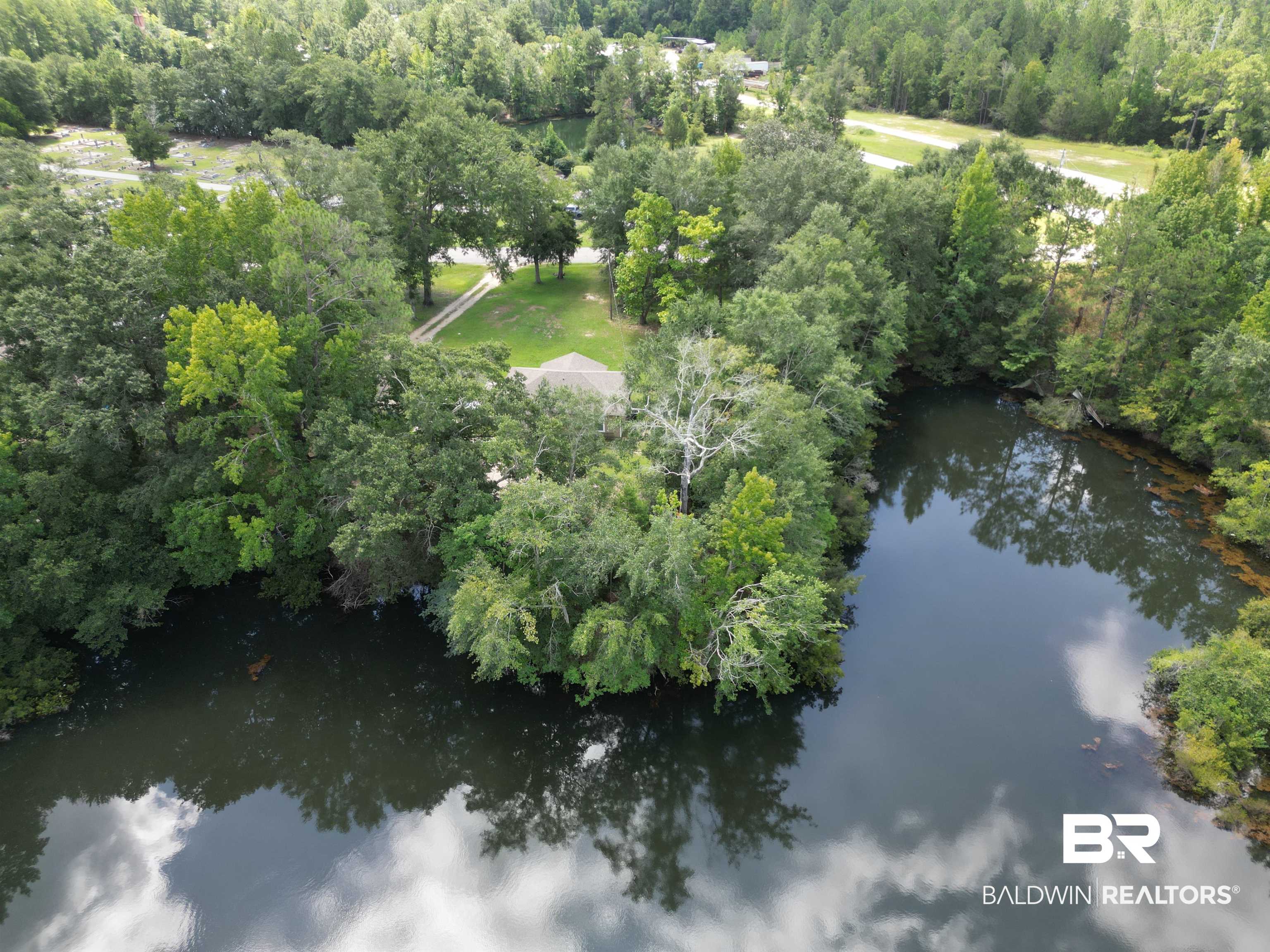 820 Fannie Road Century, FL 32535 - Photo 11 of 29 Aerial overview of property's location featuring a large body of water and a heavily wooded area