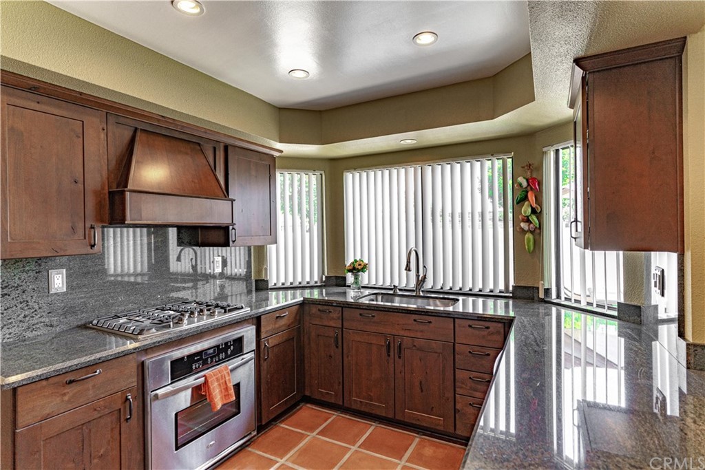 1435 Athena West Covina, CA 91790 - Photo 15 of 45 a kitchen with stainless steel appliances granite countertop a stove a sink and a microwave