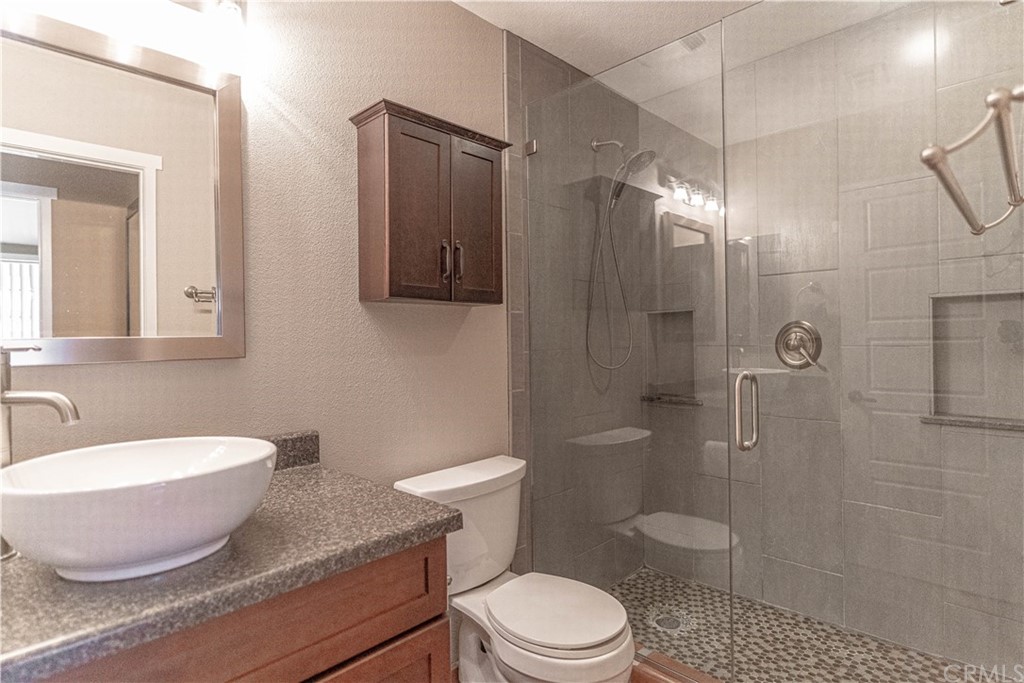 1435 Athena West Covina, CA 91790 - Photo 26 of 45 a bathroom with a granite countertop toilet sink shower and mirror