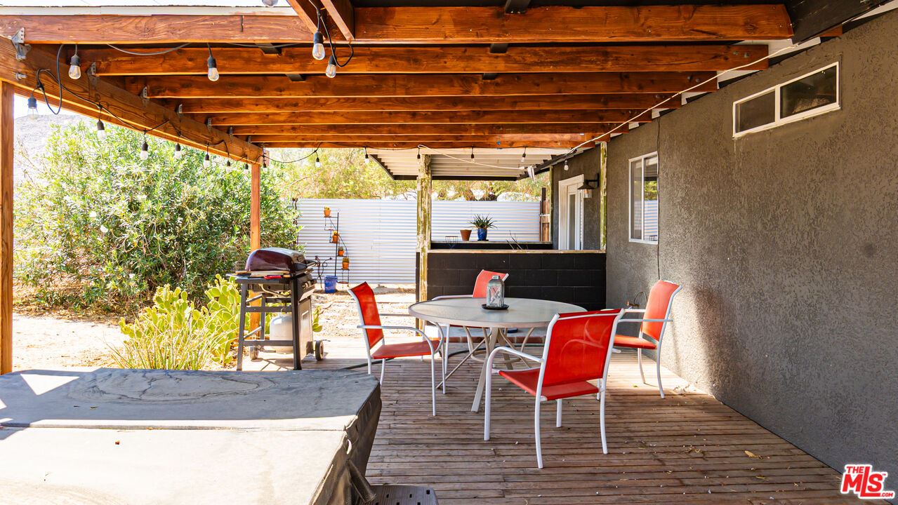 62033 Bonair Road Joshua Tree, CA 92252 - Photo 34 of 53 a patio with water glass top table and chairs