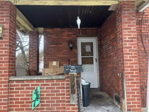 a brick building with a bench and porch