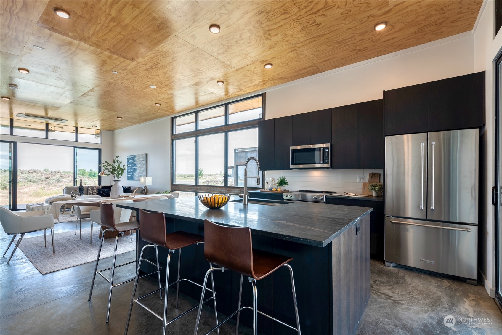 232 (lot 31) Nw Rattlesnake Point Road Quincy, WA 98848 - Photo 5 of 37 a kitchen with stainless steel appliances granite countertop a refrigerator a stove a sink a dining table and chairs