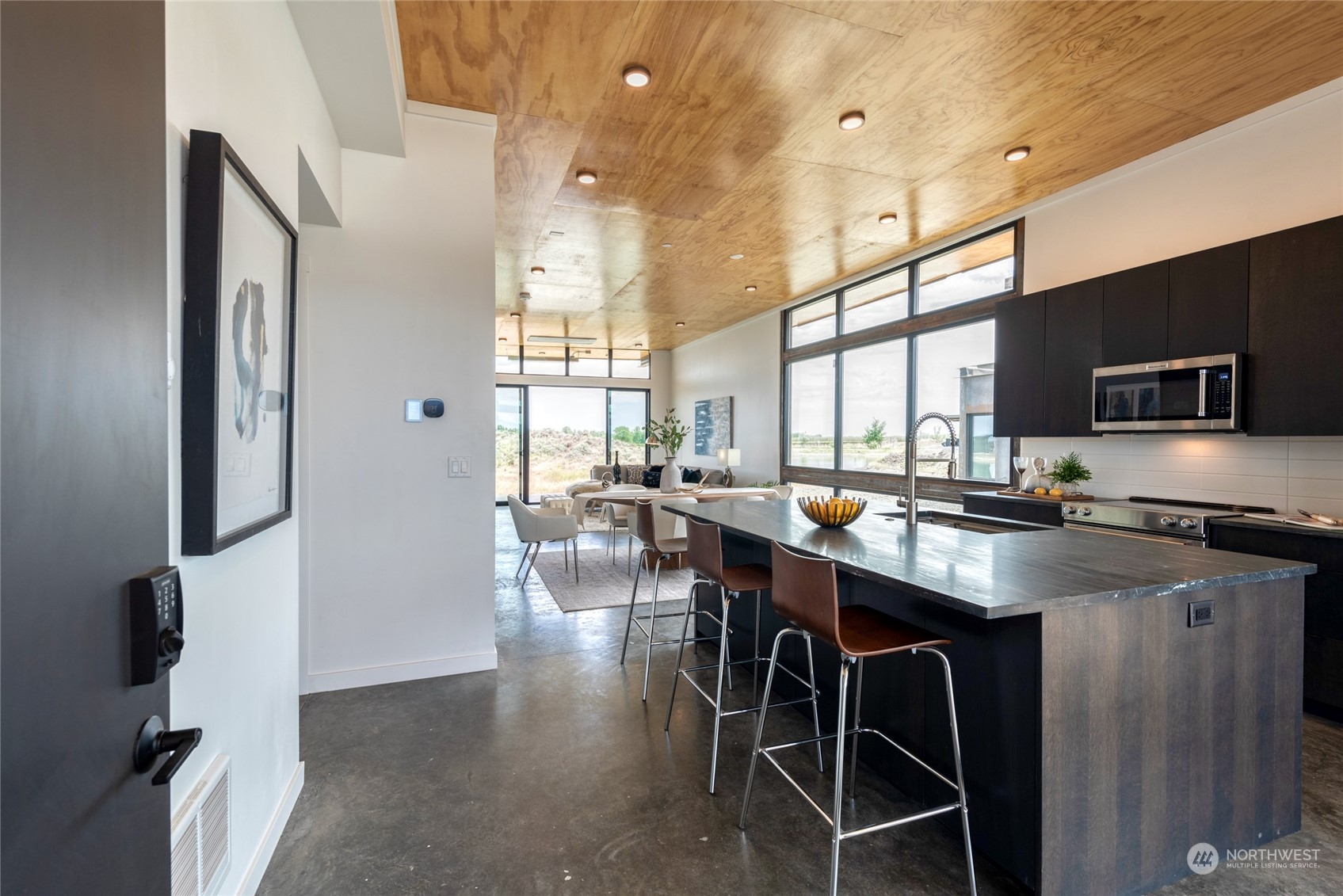 232 (lot 31) Nw Rattlesnake Point Road Quincy, WA 98848 - Photo 9 of 37 a kitchen with stainless steel appliances granite countertop table chairs sink and stove top oven