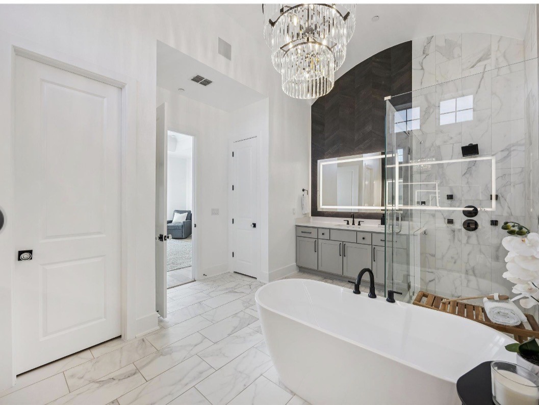 6817 Davenport Divide Road Austin, TX 78738 - Photo 14 of 28 a bathroom with a tub sink and mirror