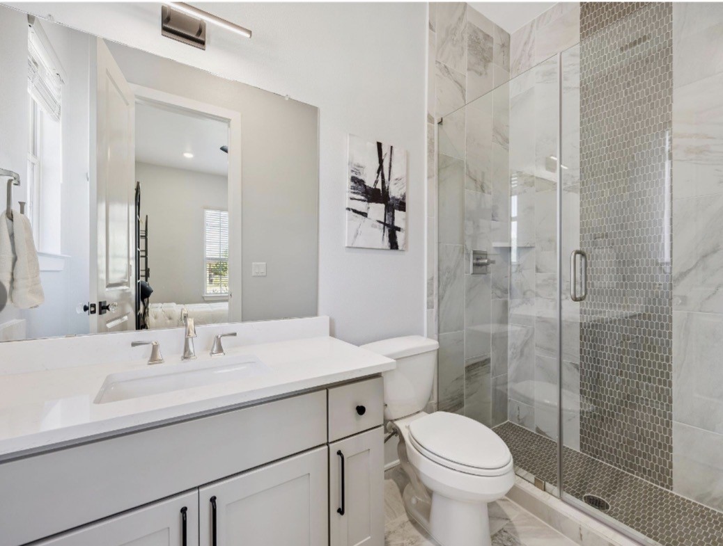 6817 Davenport Divide Road Austin, TX 78738 - Photo 15 of 28 a bathroom with a sink toilet and shower
