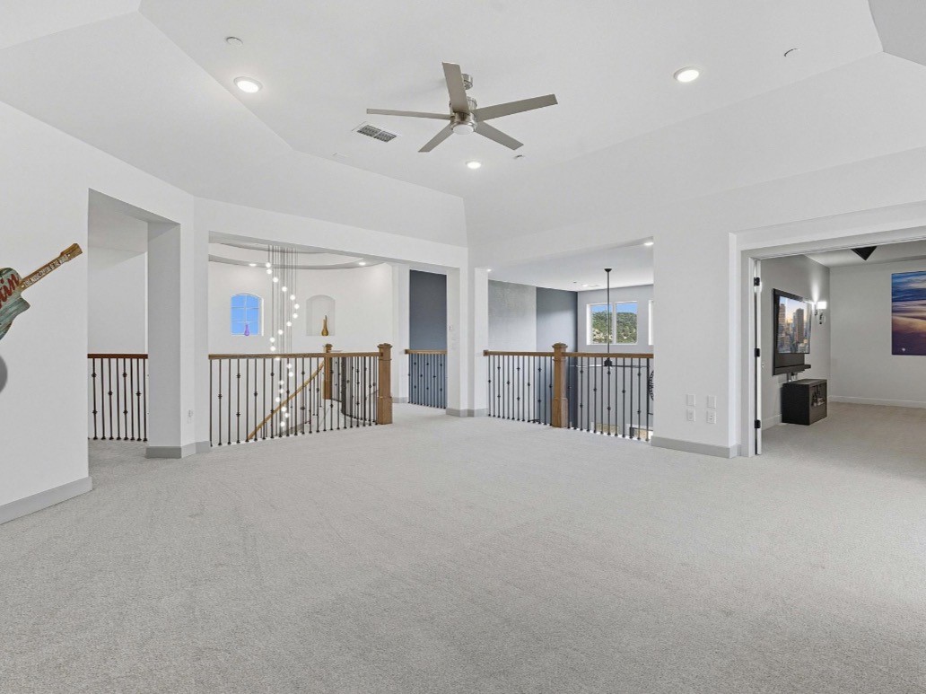 6817 Davenport Divide Road Austin, TX 78738 - Photo 21 of 28 a view of a livingroom with furniture and a ceiling fan