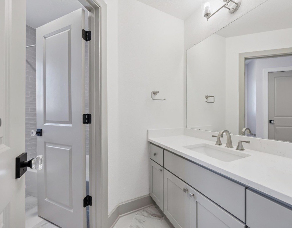 6817 Davenport Divide Road Austin, TX 78738 - Photo 22 of 28 a bathroom with a sink and mirror