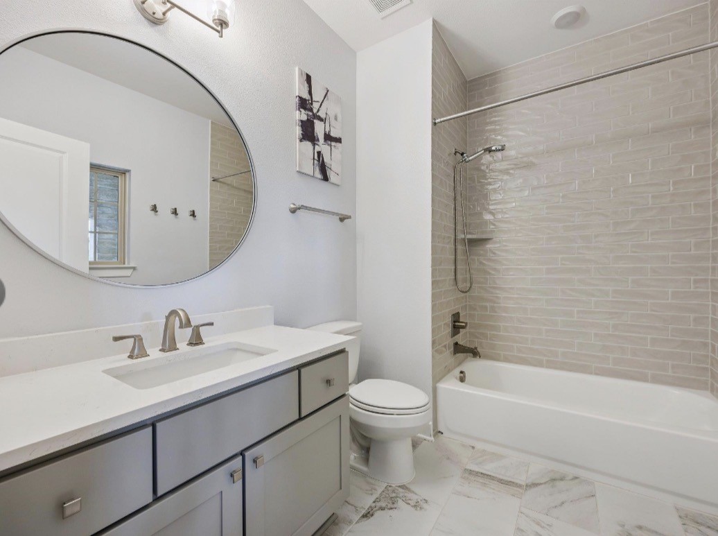 6817 Davenport Divide Road Austin, TX 78738 - Photo 23 of 28 a bathroom with a sink a toilet and a mirror