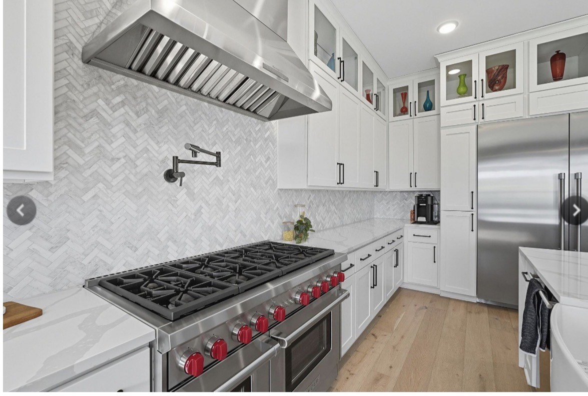 6817 Davenport Divide Road Austin, TX 78738 - Photo 6 of 28 a kitchen with a stove a refrigerator and cabinets