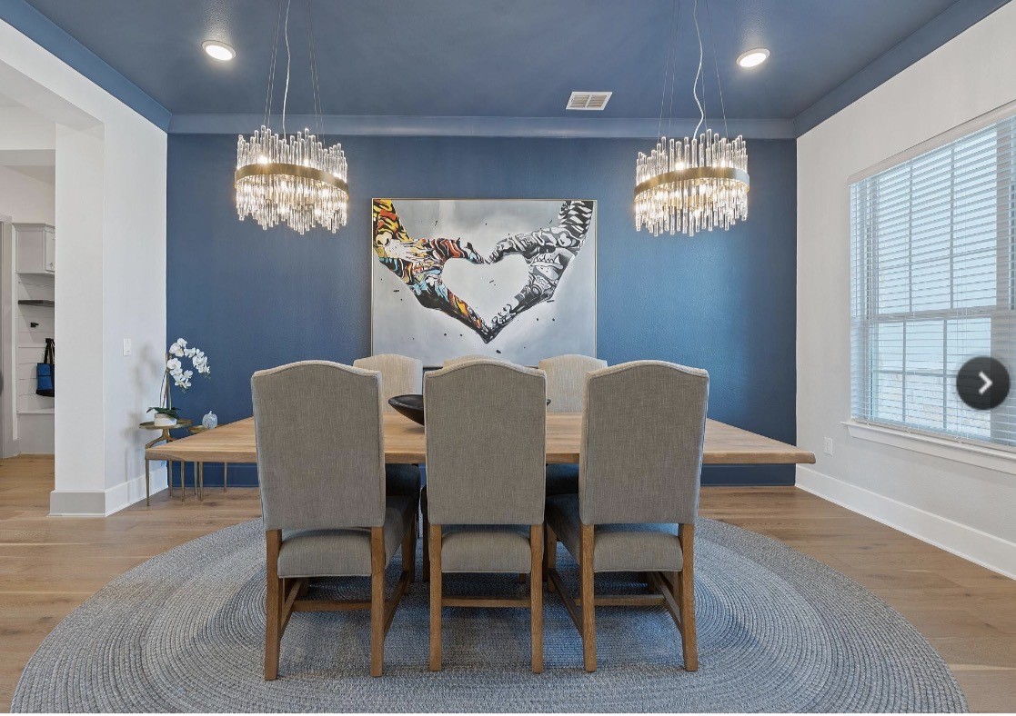6817 Davenport Divide Road Austin, TX 78738 - Photo 9 of 28 a view of a dining room with furniture a chandelier and wooden floor