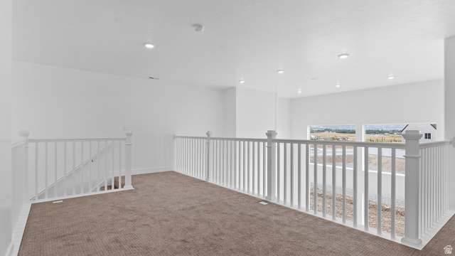 4170 North 560th West, Unit 6 Tooele, UT 84074 - Photo 14 of 20 Expansive open loft area featuring plush brown carpeting and white railing