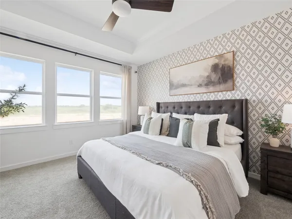 a bedroom with a bed and a dresser with mirror