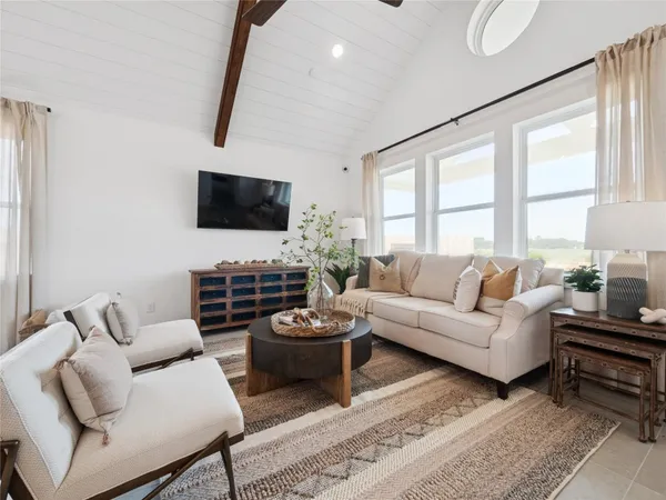 a bedroom with a bed painting on the wall and a window