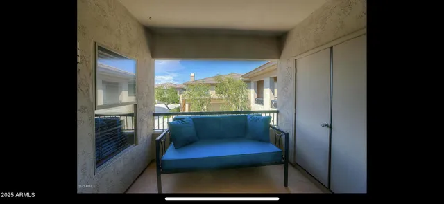 a view of a room with furniture and a window