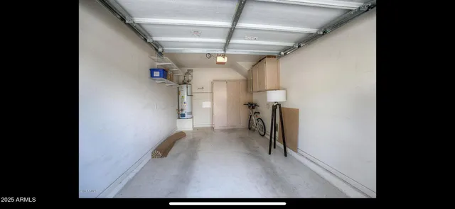 a view of a hallway with a white kitchen