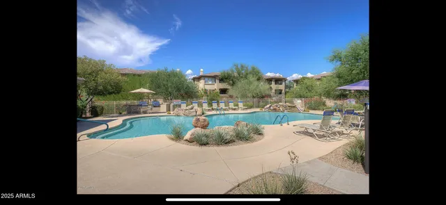 a view of a room with wooden floor windows and a chandelier