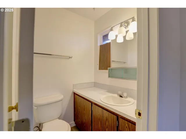 a bathroom with a sink a toilet and mirror